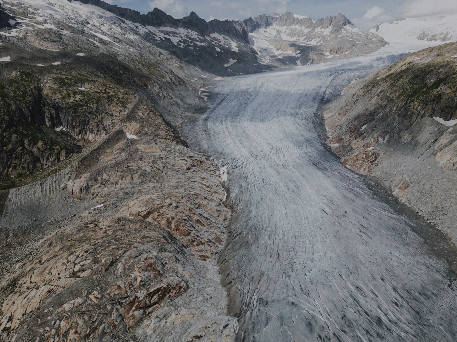 An aerial view of a glacier with mountains in the background